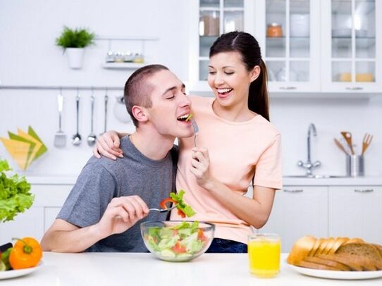A woman feeds a man with products that naturally increase her potential
